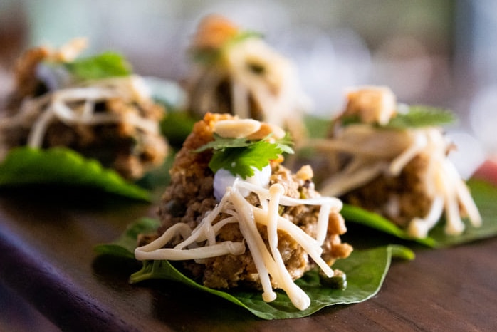Delicious canapes served on betel leaves.