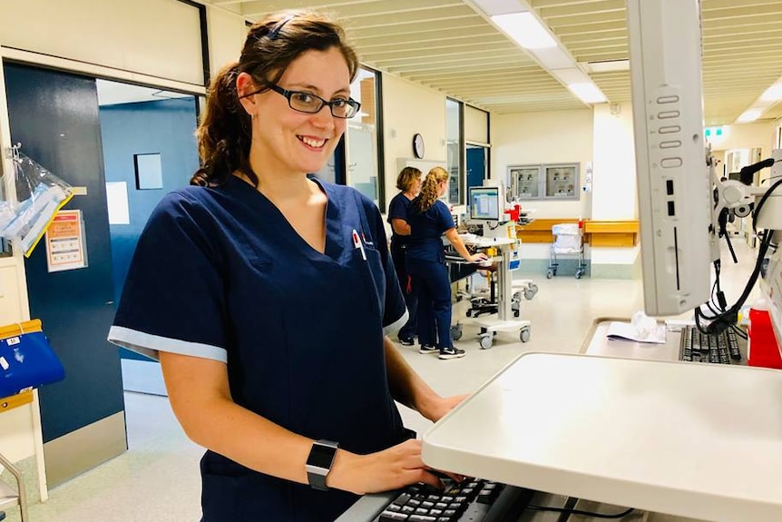 Amanda Nix at a computer in a hospital.