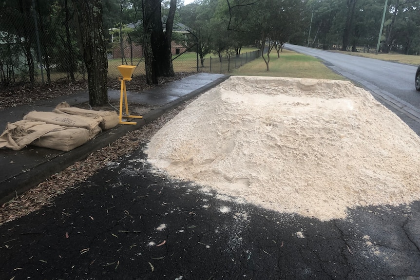 sand piled up on a road in preparation for a flooding event in the hawkesbury