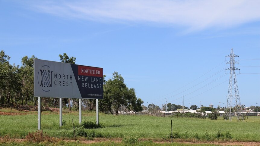 A sign advertising Northcrest in a paddock