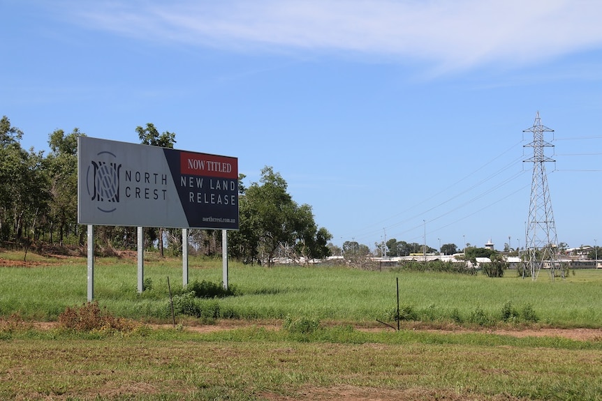 A sign advertising Northcrest in a paddock