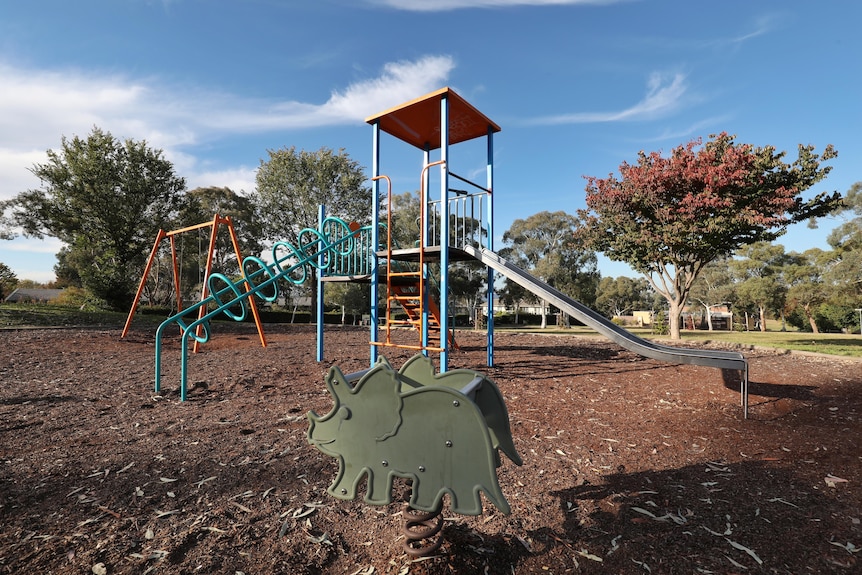 A small playground set with a swingset and slide in suburban Duffy. 