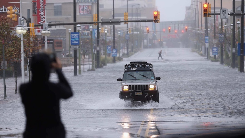 A car drives on a flooded street in Atlantic City