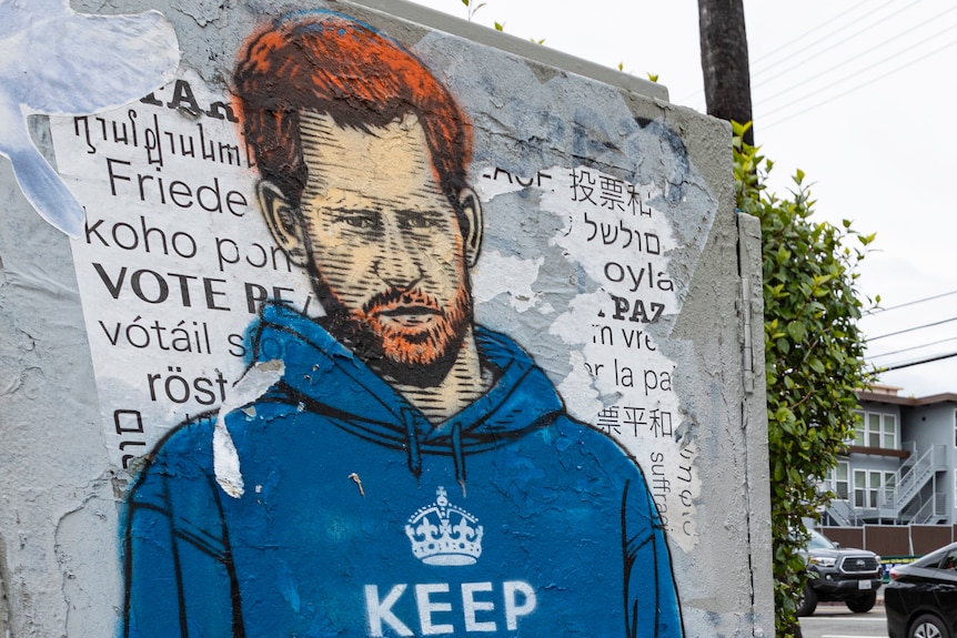 Box on city street corner with drawing of a red-headed man in blue sweater