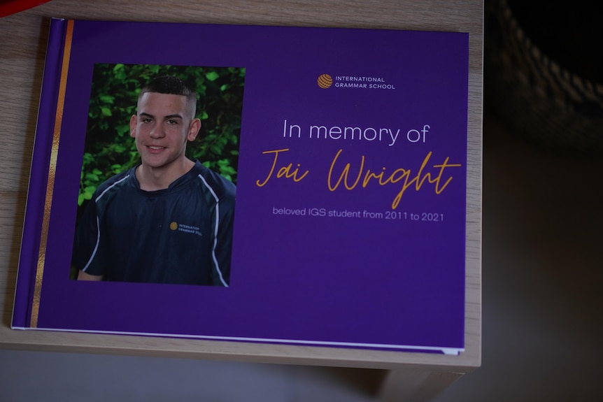 A purple hard covered photo album with a photo of Jai on the front. The words 'in memory of Jai Wright ' appear on the cover