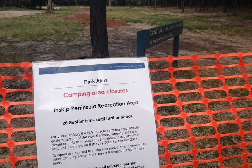 A campground closed sign at the site of a near-shore landslide at Inskip Point on Queensland's Cooloola Coast