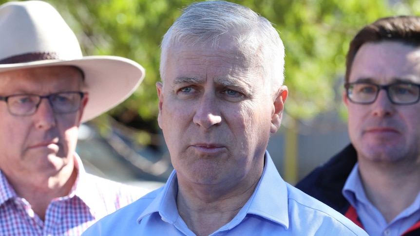 Michael McCormack speaks in front of Mark Coulton and David Littleproud