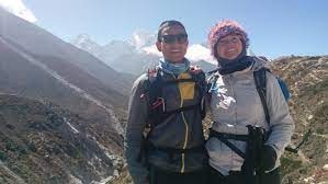 Som and Kirsty pose with Himalayan hills & mountains in the background