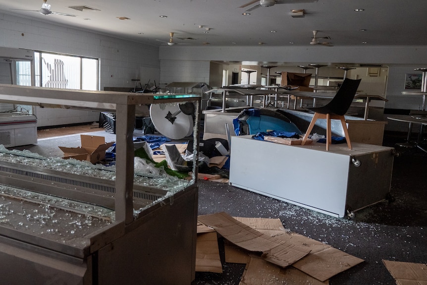 Smashed bain marie and tables piled in the abandoned BHP cafeteria in Moranbah, November 2021.