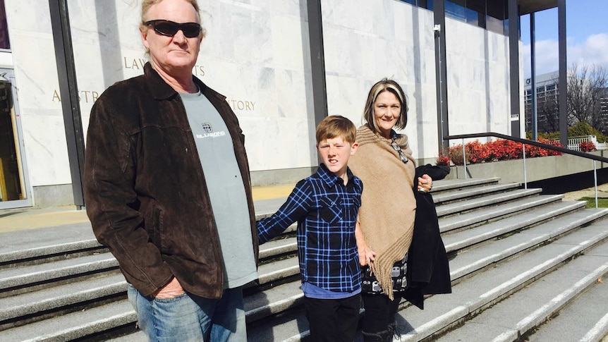 Dog attack victim Jack Hartigan, 11, with his parents outside the ACT Supreme Court in 2015.