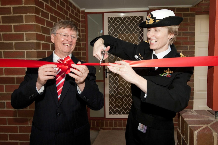 Peter Howman and Captain Katherine Richards, RAN, open the first upgraded house of HMAS Cerberus.
