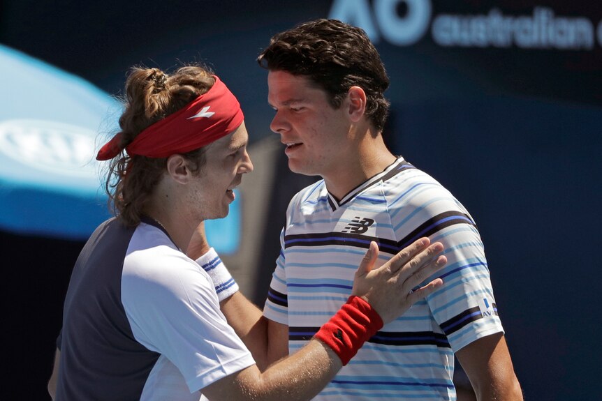 Milos Raonic congratulates Lukas Lacko at the Australian Open