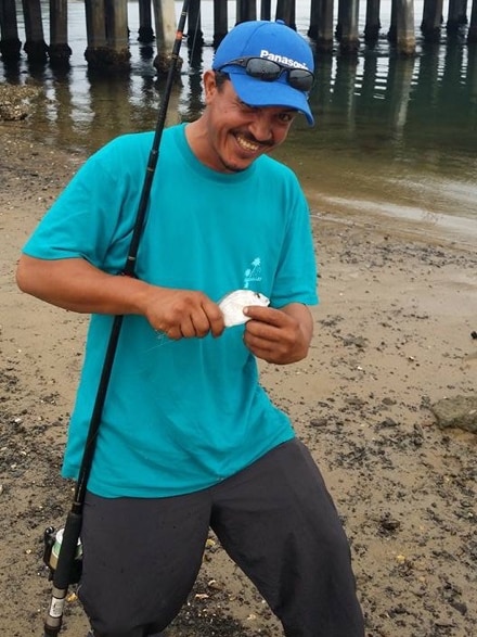 Kelly Ventigadoo fishing on a beach