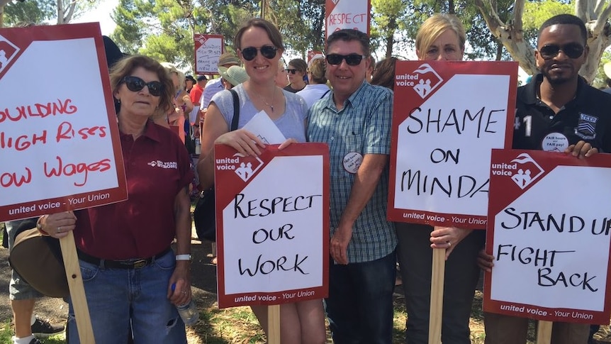 Minda workers with signs at the protest.