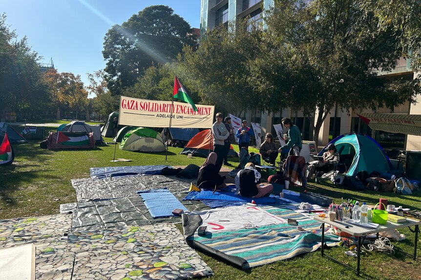 Tents on a university ground and signs. 