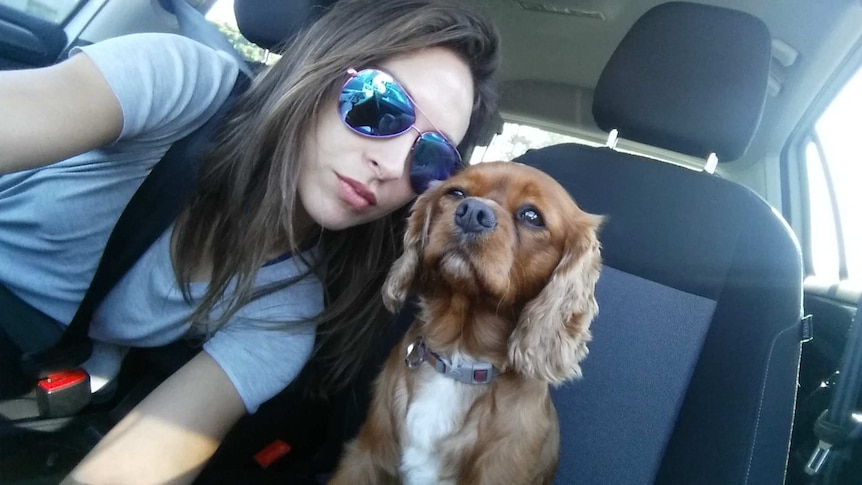 Genevieve Wood and 'Coco' pose in the front car seats