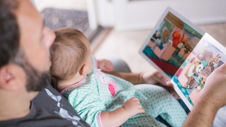 Dad reads to baby