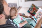 Dad reads to baby