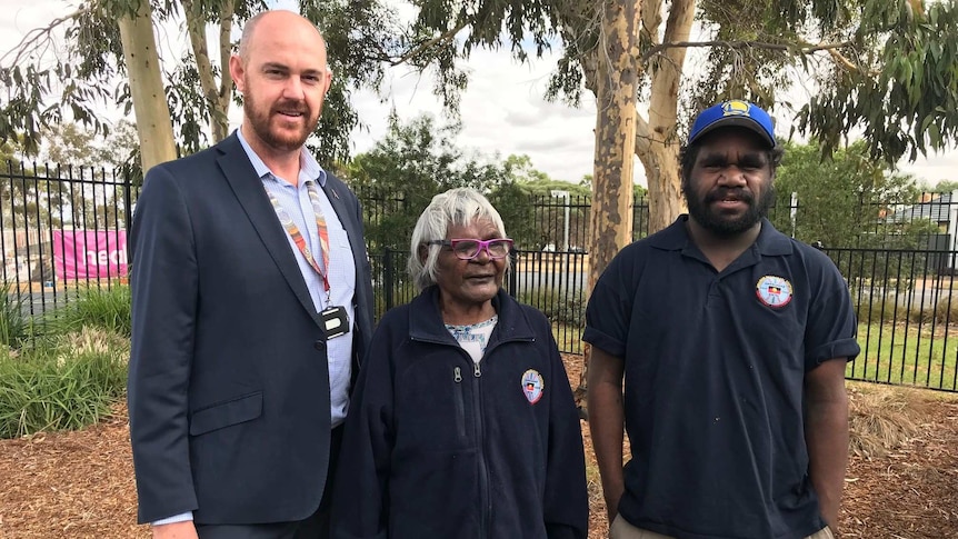 Aboriginal Health Services executive Kurt Towers stands next to two traditional Aboriginal healers