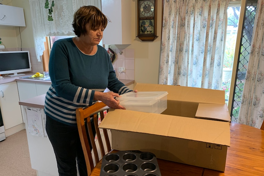 Hove resident Judith Paterson unpacks a box.