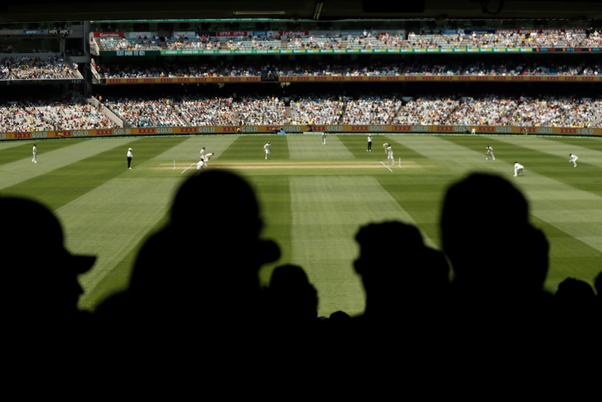 A crowd watches cricket at the MCG