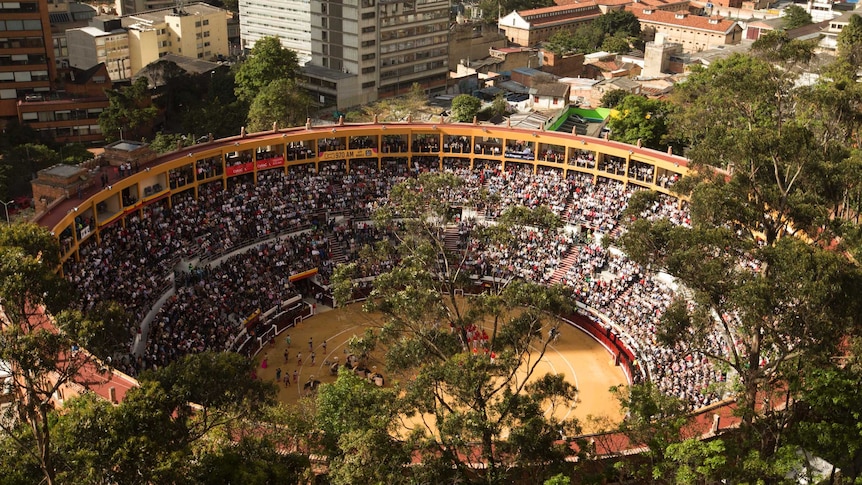 Stadium filled with people watching bullfighting