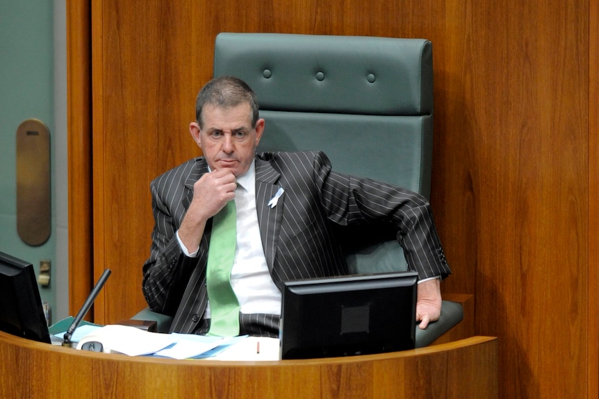 The newly elected Speaker, Peter Slipper, listens to Tony Abbott.
