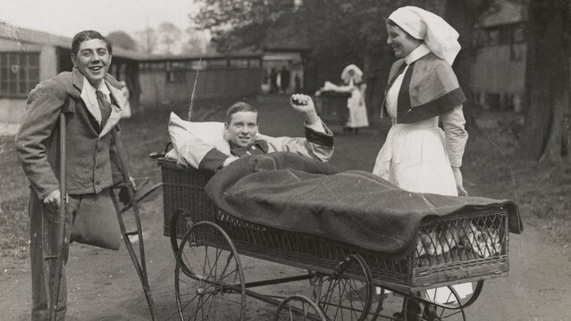 Two wounded soldiers and a nurse outdoors