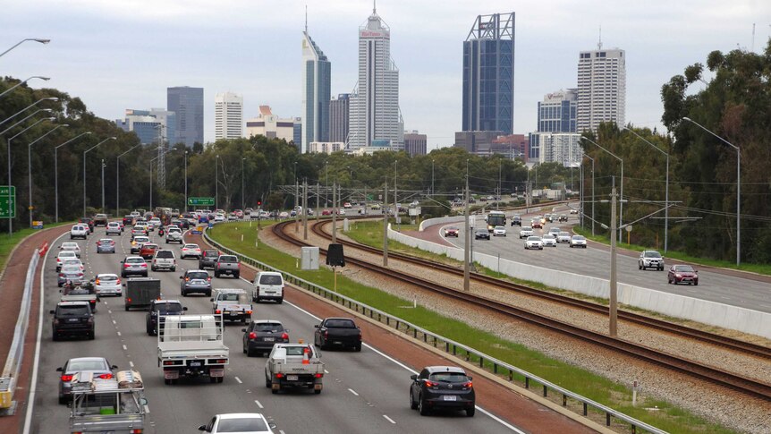 Traffic on the freeway with Perth city as backdrop.