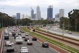 Traffic on the freeway with Perth city as backdrop.