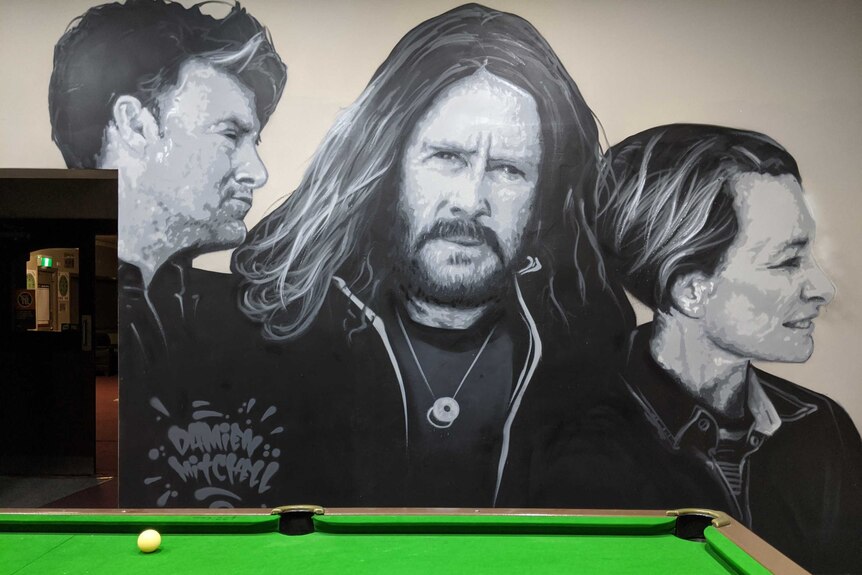 Mural of band Spiderbait painted on a pub wall in Finley