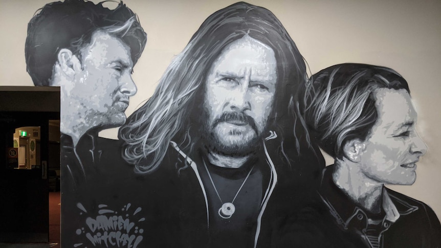 Mural of band Spiderbait painted on a pub wall in Finley