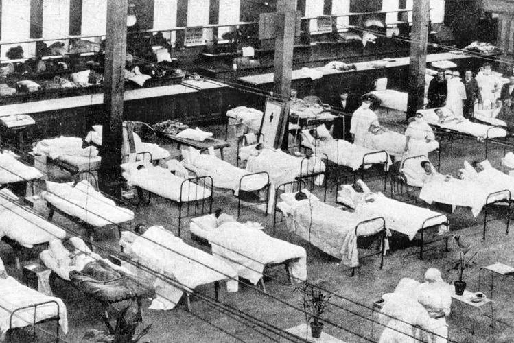 Black and white picture of the Great Hall, rows of beds and nurses
