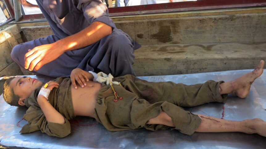 An injured Pakistani arrives at hospital following a suicide bombing at a mosque in the Mohmand tribal district.