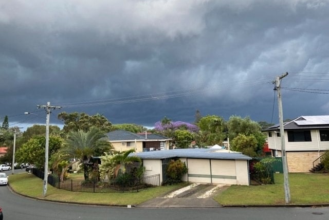 Clouds form over suburban houses.