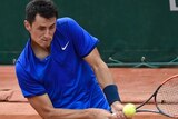 Australia's Bernard Tomic hits a return to American Brian Baker at the French Open.