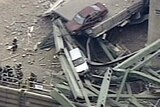 Cars sit precariously after highway bridge collapse