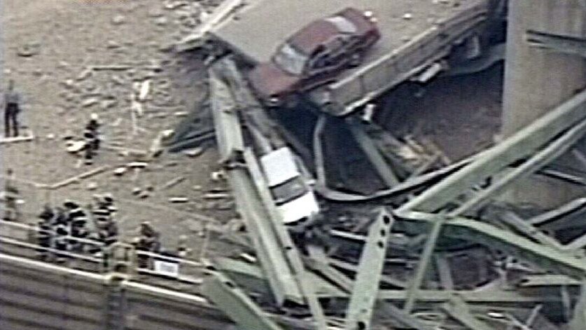Cars sit precariously after highway bridge collapse