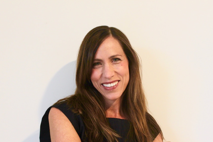 A woman with long brown hair.