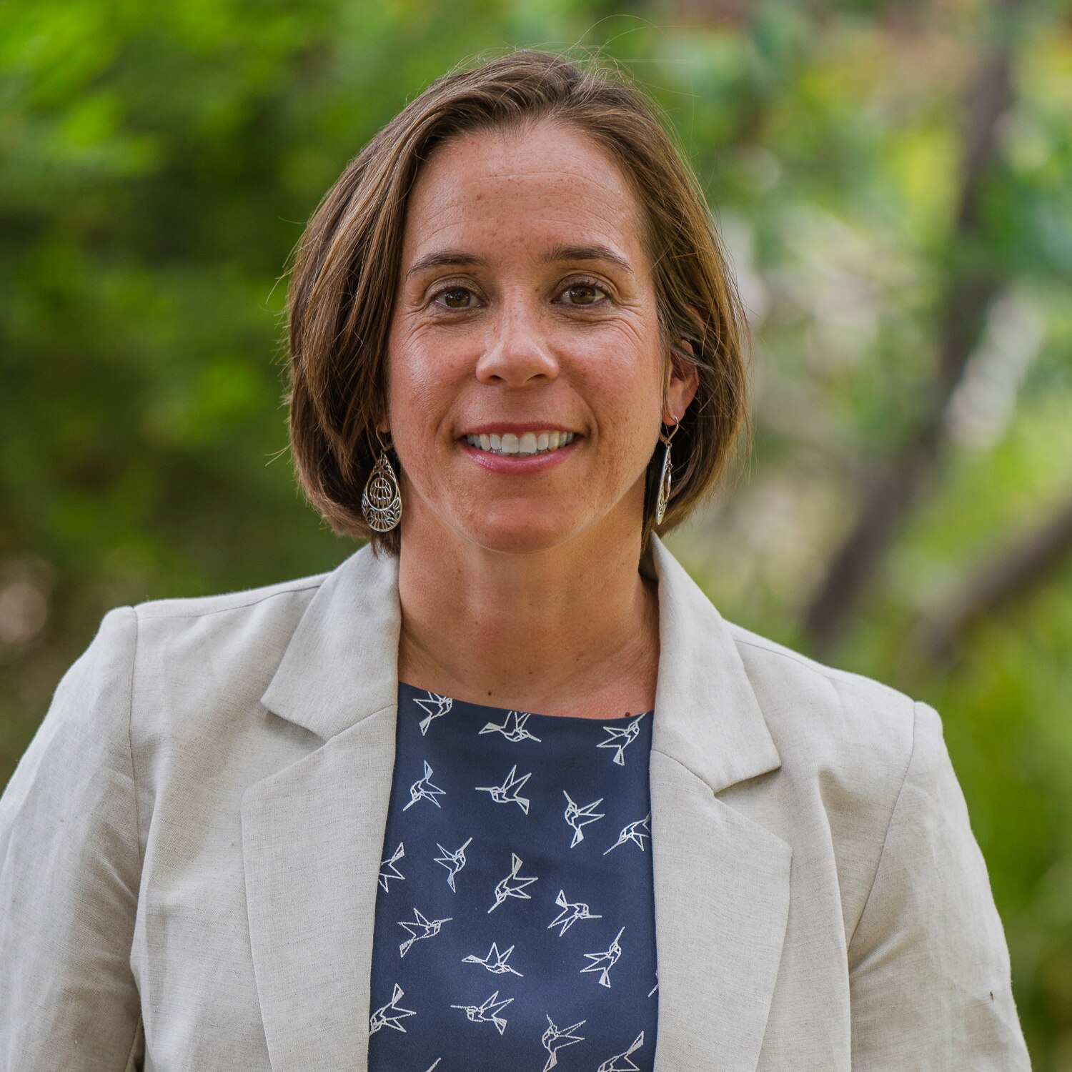 A smiling, middle-aged woman with short, fark hair.