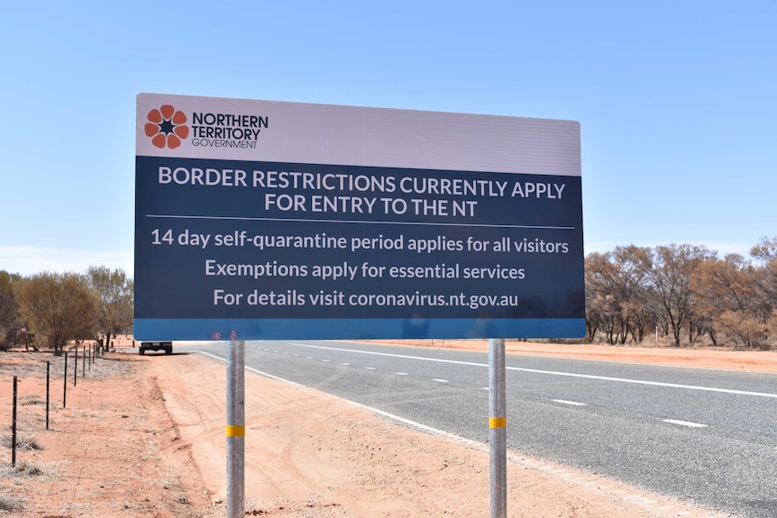 A sign in the red desert detailing the Northern Territory's border rules.