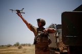 A soldier releases a drone.