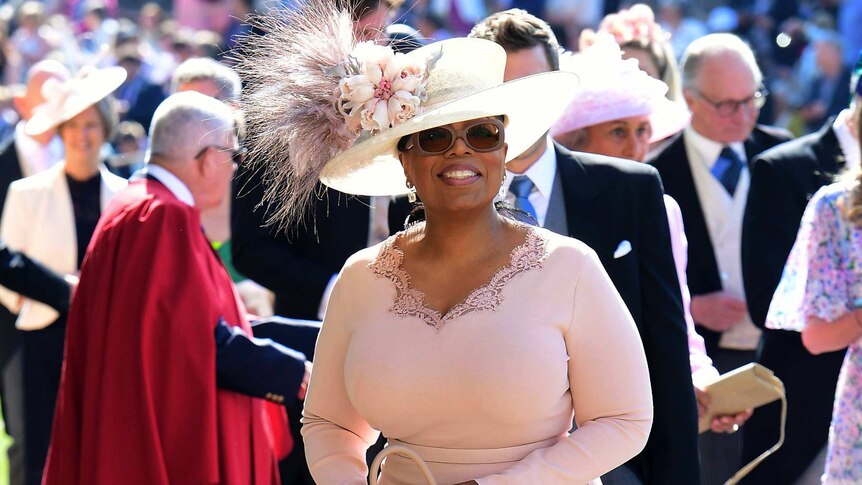 Oprah Winfrey smiles as she arrives at St George's Chapel at Windsor Castle.
