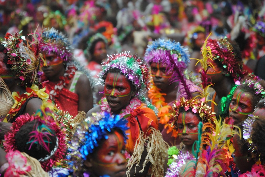 Women in tinsel headdresses and grass skirts dance the Napen Napen at the Nekiowar festival in 2012.