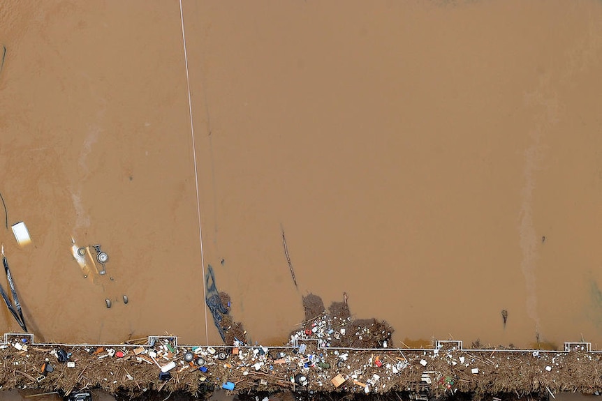 A railway crossing at Grantham littered with debris from floodwaters that swept through the town on January 12