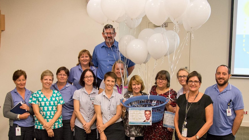 Cairns Hospital's senior nurse team hold white balloons as they launch their Christmas appeal for victims of domestic violence.