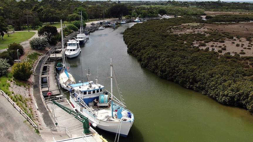 Aerial image of boats moored along the river at the Port Franklin wharf.