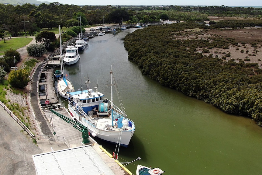 Aerial image of boats moored along the river at the Port Franklin wharf.