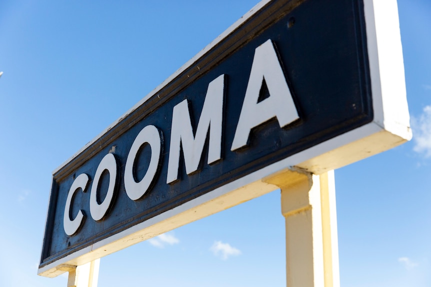 A retro Cooma train station sign