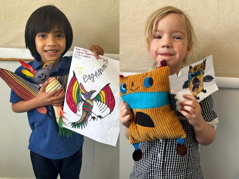 Two young children holding toys and pictures of them